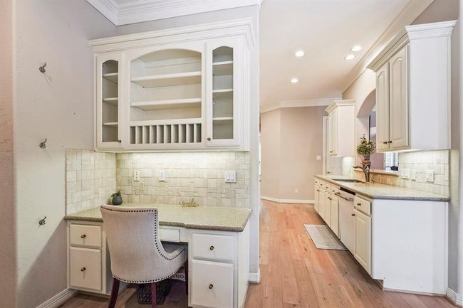 Built-in desk space adjacent to the kitchen and living room. | Image 27