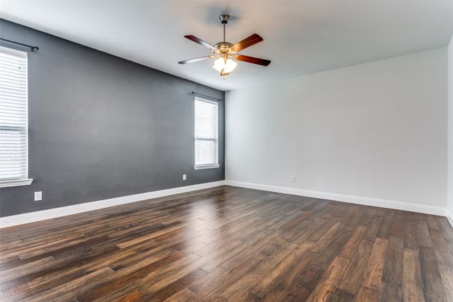 Spare room featuring dark hardwood / wood-style flooring, a wealth of natural light, and ceiling fan | Image 15