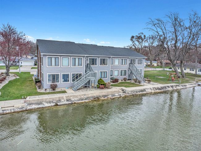 Lake side view of Condo - Unit A is bottom left. Back entry door under stairs | Image 20