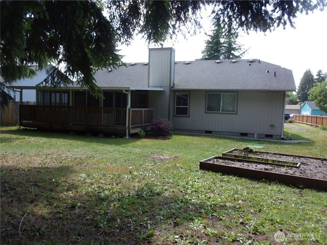 Picture of the back of the home from under the fir trees. | Image 5