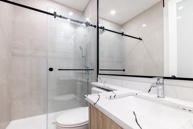 Full bath featuring a shower stall and vanity | Image 22