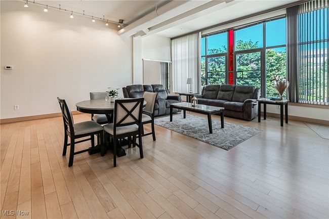 Dining area featuring track lighting and light wood-style flooring. | Image 10
