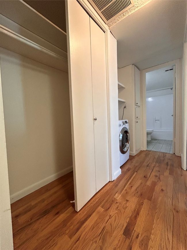 Laundry room with wood finished floors and washer / dryer | Image 6