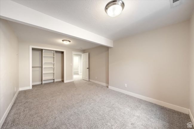 Unfurnished bedroom featuring carpet floors, a closet, baseboards, and visible vents | Image 48