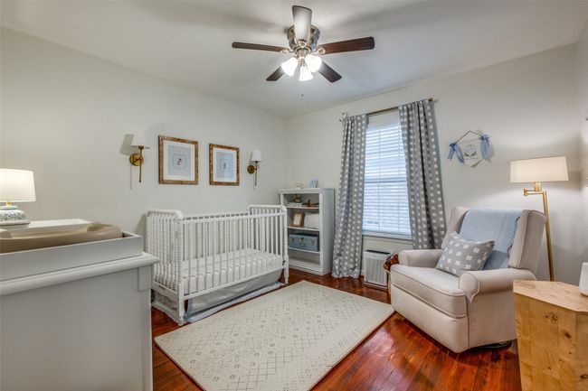 Bedroom featuring a nursery area, wood finished floors, and ceiling fan | Image 27