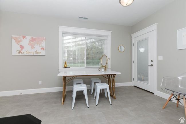 Dining space featuring baseboards, visible vents, and light tile patterned floors | Image 51