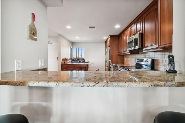 Granite counter breakfast bar. | Image 17