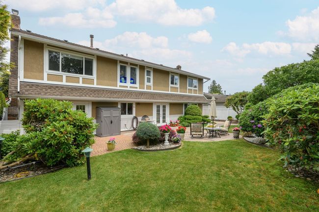 Rear view of house featuring stucco siding, a patio, and french doors | Image 29
