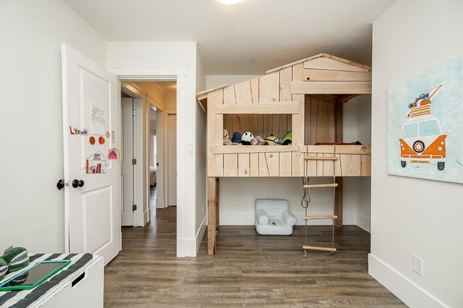 Bedroom featuring wood finished floors and baseboards | Image 16