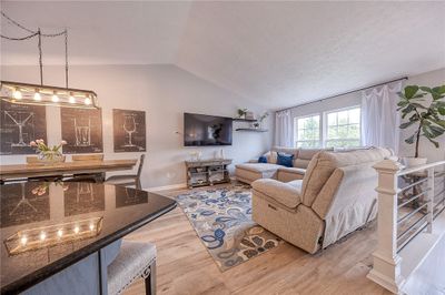 LOVE this open concept space, created when the Sellers removed walls! The living room, dining area and gourmet kitchen flow seamlessly into one gorgeous, inviting area perfect for daily living and large family gatherings. | Image 3