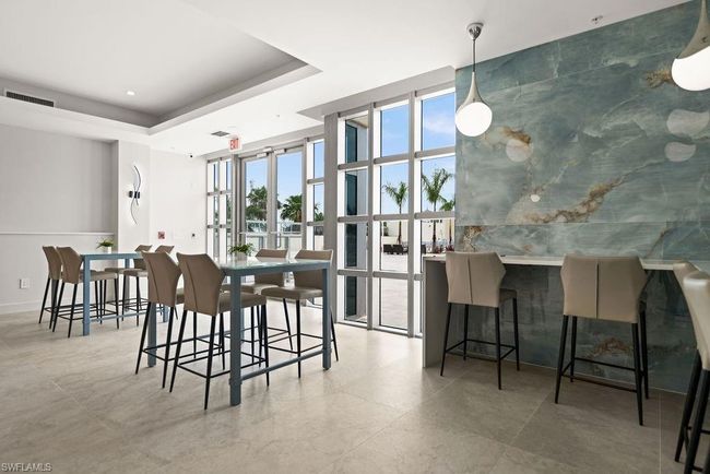 Dining area featuring light tile patterned flooring and a tray ceiling | Image 31