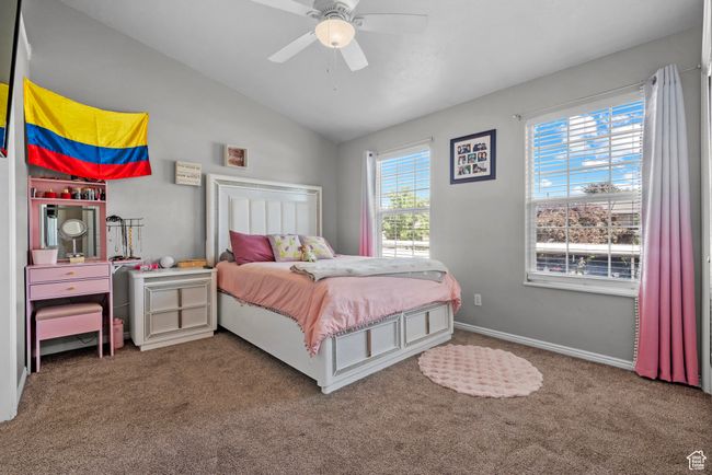 Bedroom featuring carpet, vaulted ceiling, and a ceiling fan | Image 13