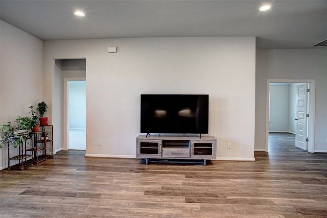 Living room with baseboards, wood finished floors, visible vents, and recessed lighting | Image 9
