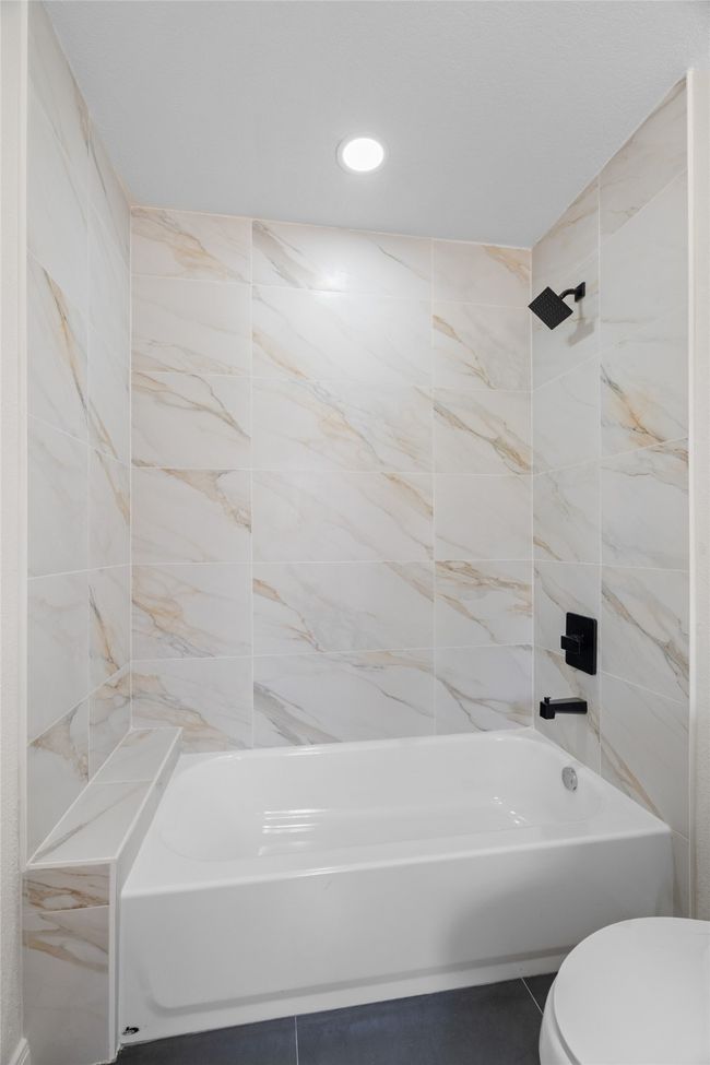 Full bath with tile patterned floors, shower / bathtub combination, toilet, and recessed lighting | Image 16