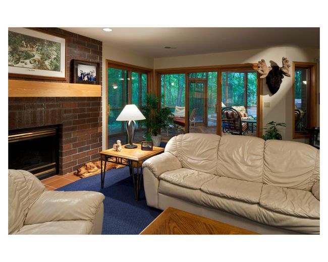 Lower level at the St. Anne House, complete with a cozy fireplace and screened-in porch | Image 89