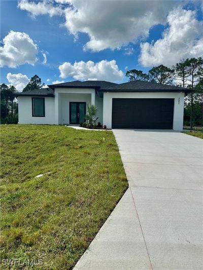 Single story home with a garage and a front lawn | Image 1