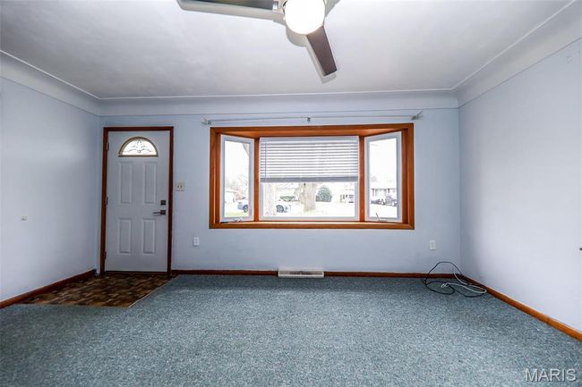 Carpeted foyer entrance with baseboards and visible vents | Image 7