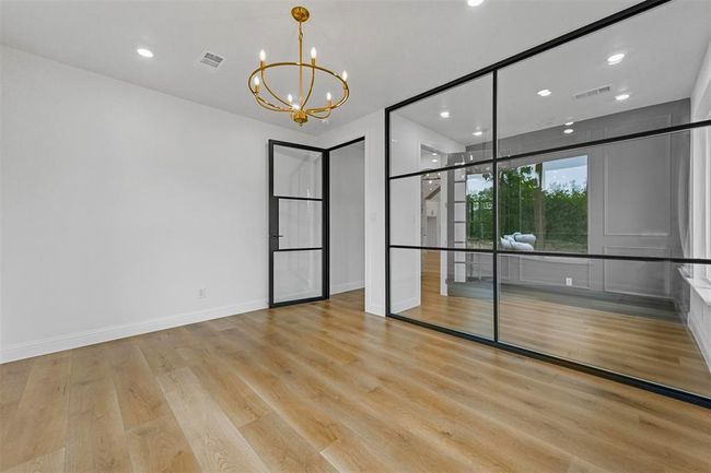 Unfurnished room featuring light wood-type flooring and an inviting chandelier | Image 24