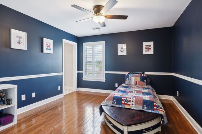 Charming upstairs bedroom with custom paint, wainscoting, and hardwood floors. | Image 27