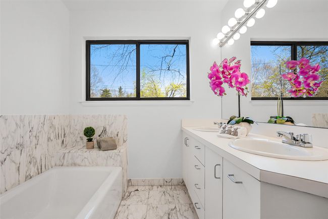 Bathroom features double sink vanity, tub and separate shower. | Image 24