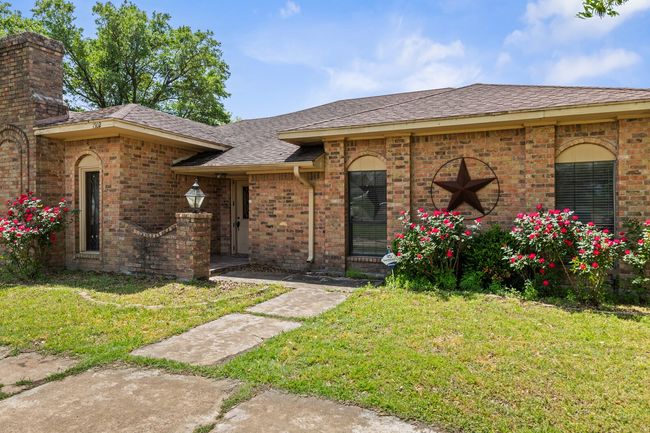 View of front of house featuring brick siding, a shingled roof, and a front yard | Image 7