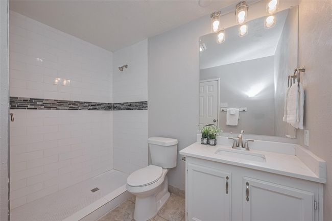 Updated primary bath with large walk-in shower and quartz countertops | Image 17