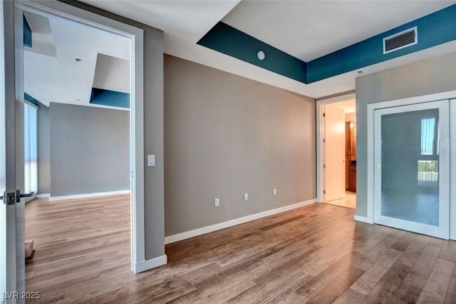 Primary bedroom featuring baseboards, wood finished floors, and visible vents | Image 21