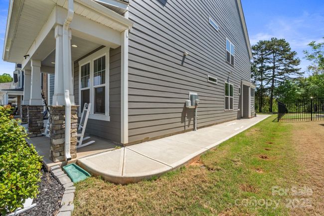 Sidewalk connecting the front porch to the back patio | Image 40