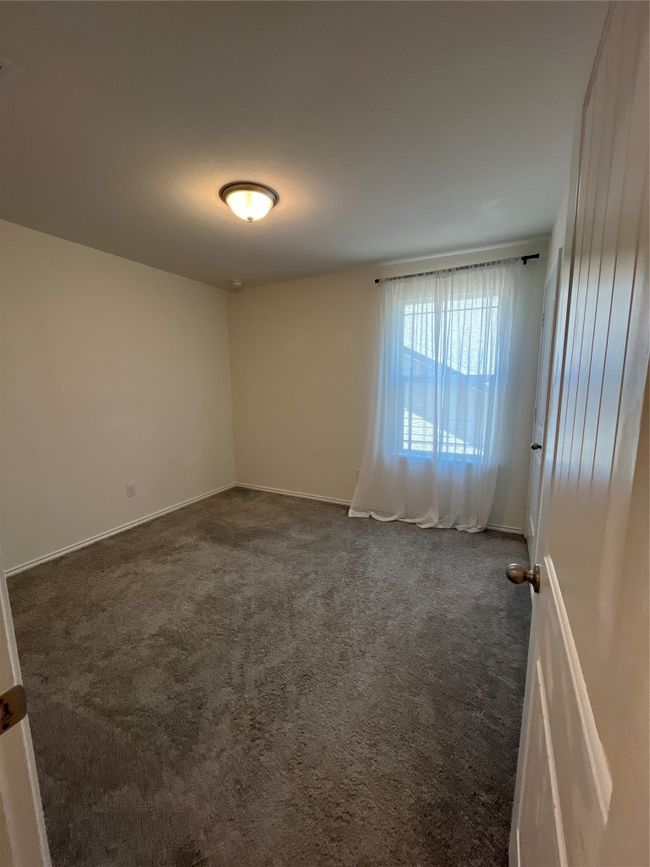 Unfurnished room with baseboards and dark carpet | Image 22