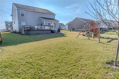 View of yard with a deck and a playground | Image 2