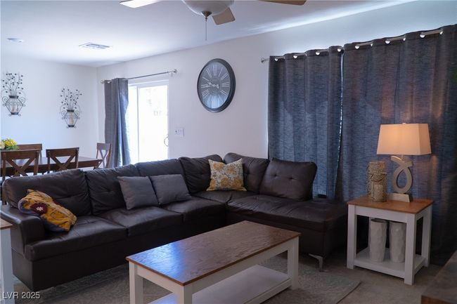 Living area with visible vents, carpet flooring, and ceiling fan | Image 33
