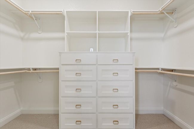 Spacious closet featuring light carpet | Image 24