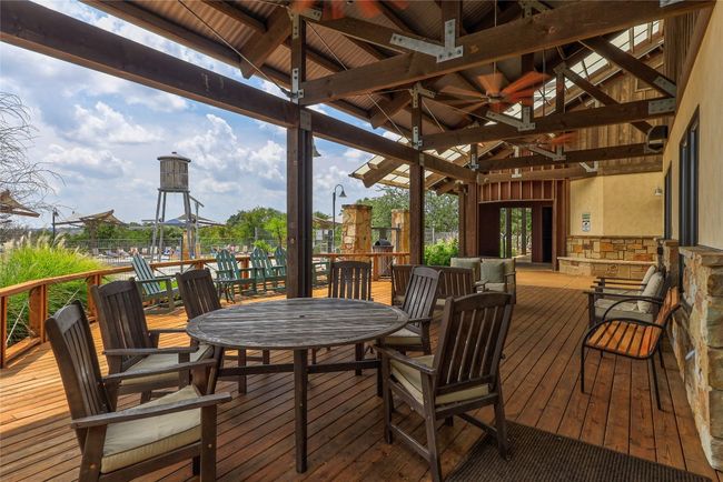 Wooden terrace with a gazebo, a ceiling fan, and outdoor dining area | Image 37
