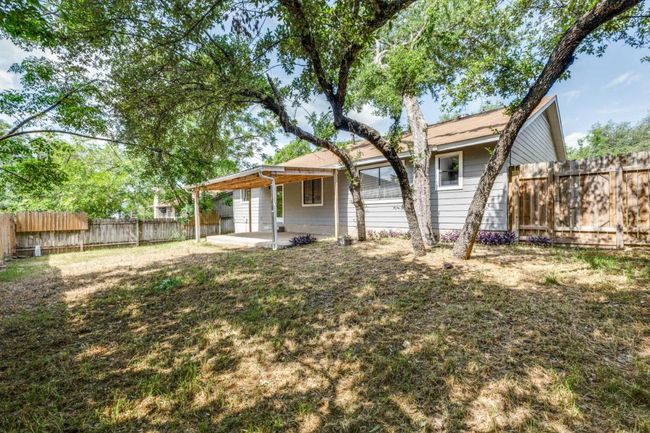 Rear view of house featuring a fenced backyard and a patio area | Image 25