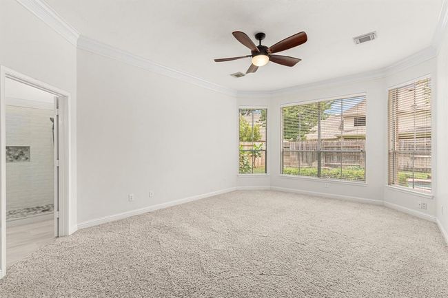 Primary bedroom has a bay window and double crown molding | Image 18