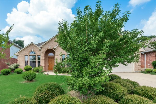 View of front of home featuring brick siding, driveway, and a front yard | Image 31