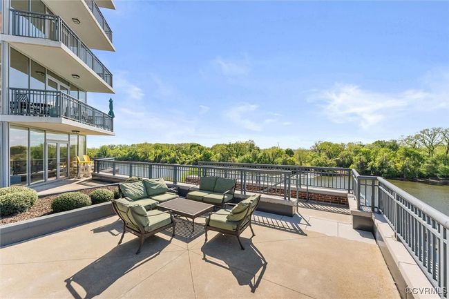 View of patio with an outdoor hangout area and a water view | Image 37