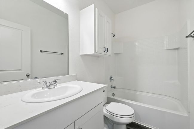 Bathroom featuring vanity and washtub / shower combination | Image 17