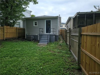 Back of property featuring central air condition unit and lawn | Image 3