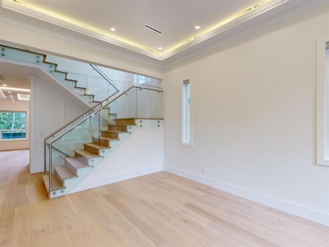Staircase with wood finished floors and recessed lighting | Image 22