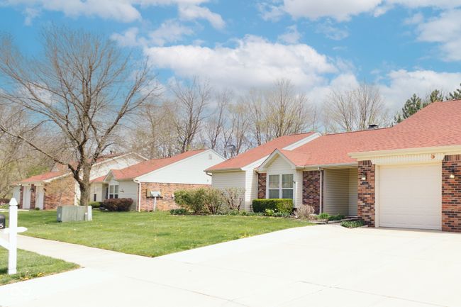 ranch-style house with driveway, brick siding, a front yard, and a garage | Image 32