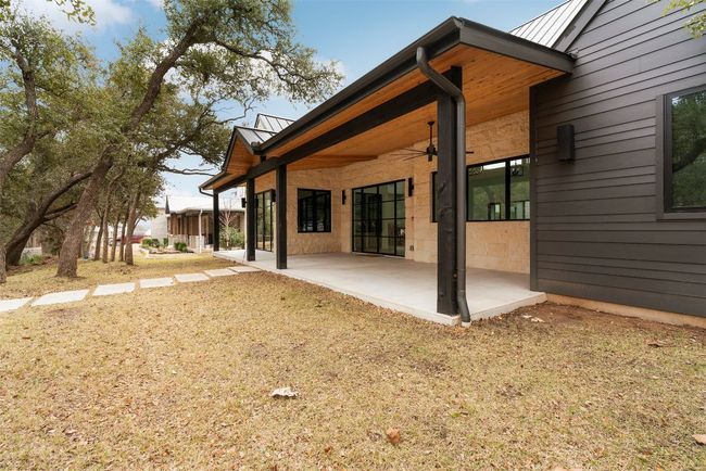 The side patio off the office offers a peaceful outdoor retreat, perfect for a morning coffee or an afternoon break with a view of the surrounding greenery | Image 5