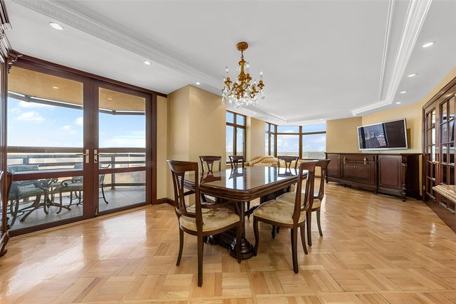 Dining space with a raised ceiling, recessed lighting, a chandelier, and ornamental molding | Image 4
