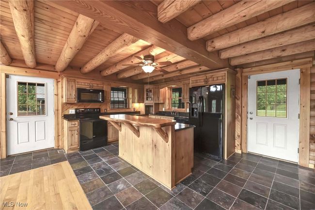 Alternate view of kitchen and both front and side entry doors. | Image 5