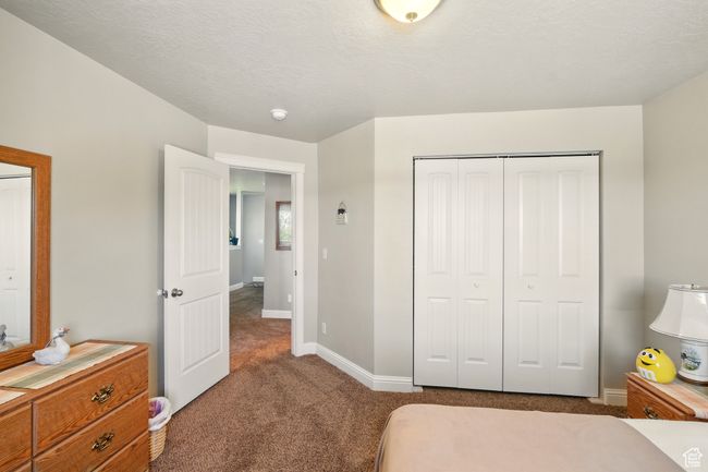 Carpeted bedroom with baseboards and a closet | Image 22