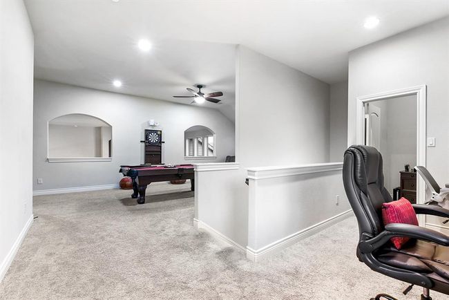 Upstairs, at the back of the home, the staircase from the kitchen leads to two built-in office spaces. These areas offer additional storage with built-in cabinets and windows that provide natural light. One office features a built-in desk designed for two people to work simultaneously. Additionally, one of the office spaces includes a door, allowing it to be used as a storage closet if extra office space isn’t needed. This flexible layout offers both functionality and convenience. | Image 28