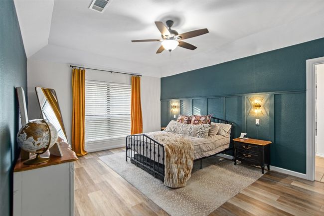 Bedroom with wood finished floors and ceiling fan | Image 13