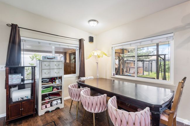 Dining area featuring dark wood-type flooring and baseboards | Image 6