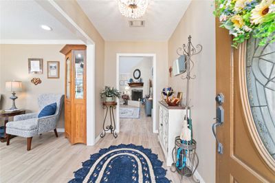 Foyer as you enter the home with decorative leaded glass design on front door | Image 3