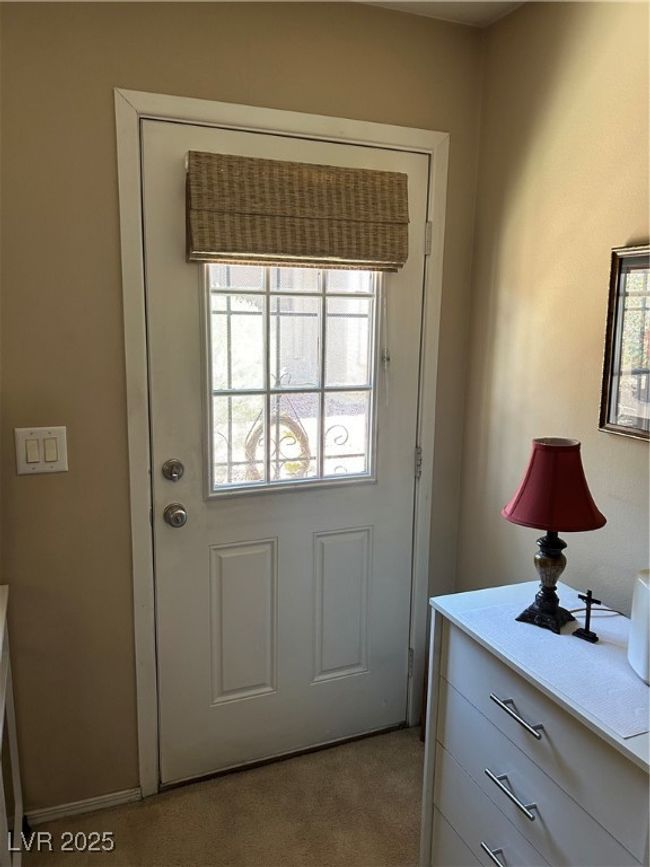 Doorway to outside featuring healthy amount of natural light and light carpet | Image 23